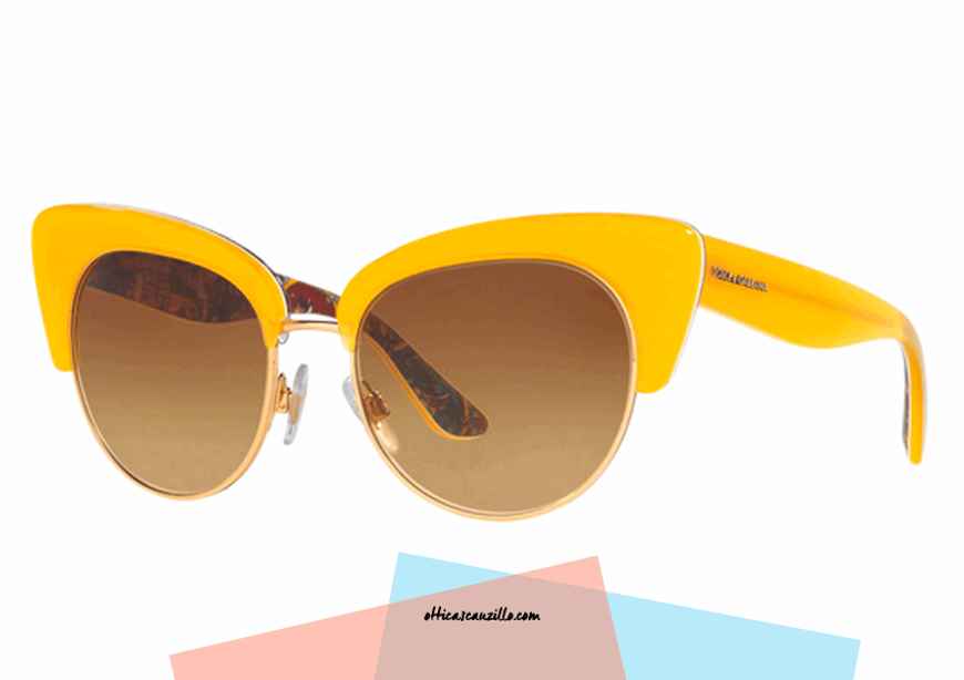 New eyewear collection sunglasses Dolce & Gabbana DG4277 col. 30352L with frame celluloid yellow and internal Sicilian cart multicolor effect. Glasses with dual frame in gilded metal and light brown gradient lenses. Female accessory from butterfly shape that enhances the quirky style.