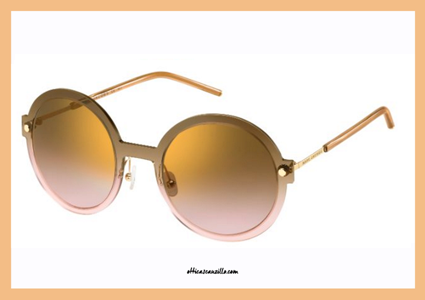 Sunglasses Marc Jacobs 29 / S col. TVXJM from the classic round shape. Marc Jacobs glasses celluloid ultra thin brown and pink gradient on a transparent basis. A complete, lenses in brown and pink gradient with mirror gold. Female accessory by the latest collection of sunglasses Marc Jacobs.