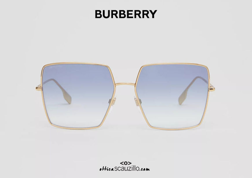 Acquista online su otticascauzillo.com il tuo nuovo occhiale da sole in metallo oro con montatura squadrata e dettaglio con iconico motivo a righe BURBERRY OBE3133 col. oro chiaro / azzurro